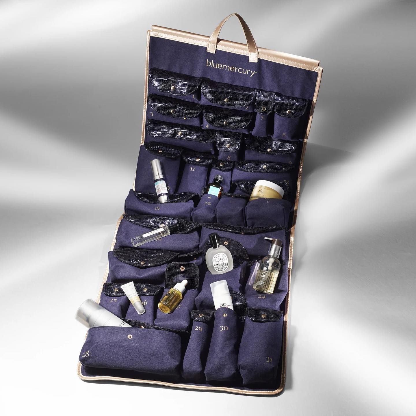 Branded merchandise created by Twelve for Bluemercury; custom branded advent calendar in navy cosmetics travel case